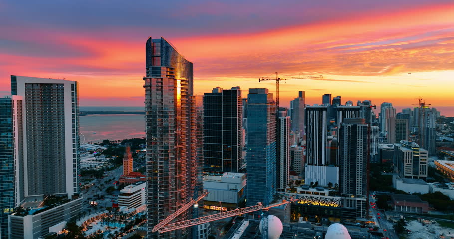 Awesome view of Miami Beach architecture in the light of setting sun. Adorable pink and purple sky under the modern skyscrapers in the city downtown. Top view.