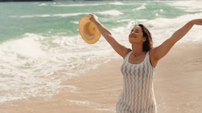 Beautiful girl with straw hat walking and enjoying sunbath at beach. Young tanned woman with closed eyes enjoying breeze at seaside. Carefree latin woman smiling with ocean in background.
 - Powered by Shutterstock - Get 15% off with code: PIKWIZARD15