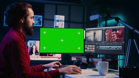 Videographer using professional software on mockup PC to create visual effects for video projects. Expert using post production techniques to edit raw clips footage on green screen computer