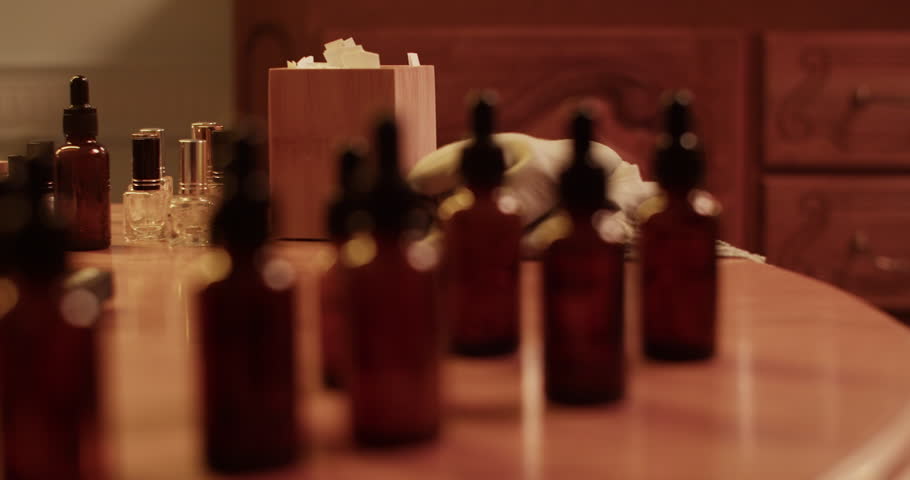 Different bottles placed on table in perfume lab