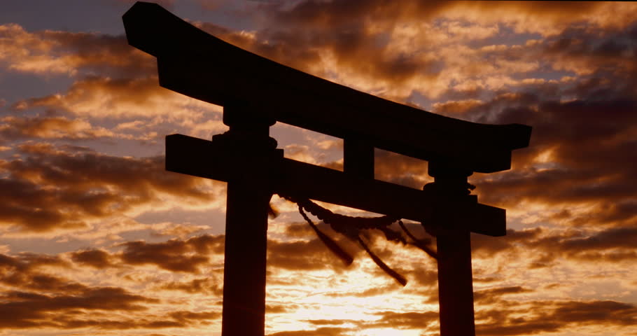 Sunset, torii gate and skies in shrine, holy place and spiritual for worship, gods and religion. Evening, prayer and sacred spot for faith, beliefs and dusk in Japan, traditional and cultural symbol