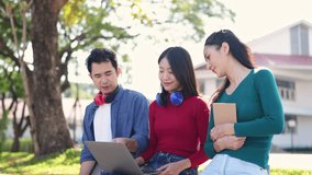 Attractive Asian university student using a laptop and headphones studying with a group of friends together online Social media technology at University Park in the morning education concept. - Powered by Shutterstock - Get 15% off with code: PIKWIZARD15