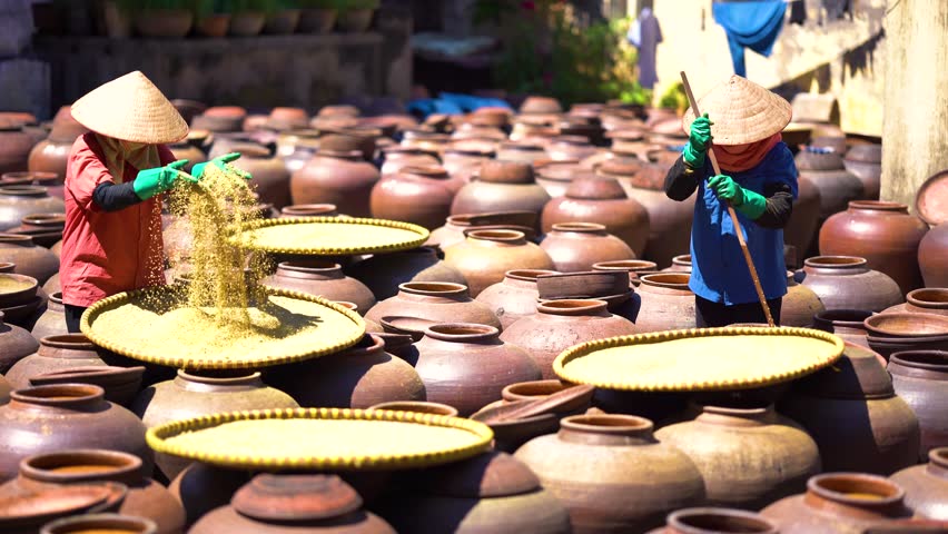 Top view of Homemade soy sauce facility in Vietnam. Two woman are making Ban soya sauce at Ban Ward, Hung Yen province, Vietnam.Soya sauce is a traditional dish of the Vietnamese people Travel concept Royalty-Free Stock Footage #3414267979