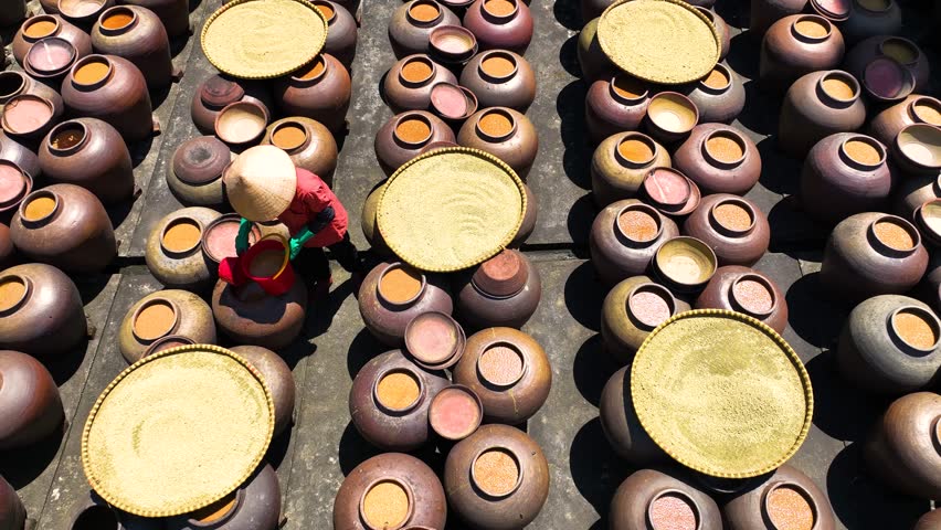 Top view of Homemade soy sauce facility in Vietnam. Two woman are making Ban soya sauce at Ban Ward, Hung Yen province, Vietnam.Soya sauce is a traditional dish of the Vietnamese people Travel concept Royalty-Free Stock Footage #3414270513