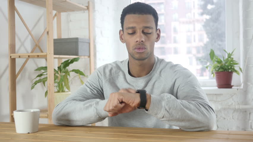 Afro-American Man Using Smartwatch for Browsing, Email and Messages