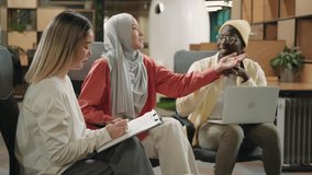 Multiethnic creative business team working on a project in the modern office.Diverse People,Business Partners,Asian Female,Caucasian man,Muslim Businesswoman,African American Businessman - Powered by Shutterstock - Get 15% off with code: PIKWIZARD15