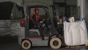 Loading pallet, Forklift safety, Warehouse navigation. Worker in warehouse is diligently operating forklift loader to relocate pallets. - Powered by Shutterstock - Get 15% off with code: PIKWIZARD15
