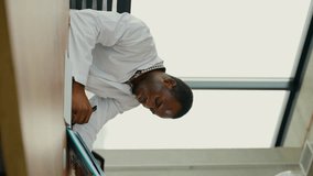 Black guy nursing student intern is preparing for the exam. Vertical video