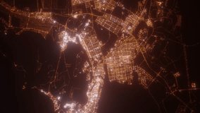 Abu Dhabi (UAE) aerial view at night. Top view on modern city with street lights. Camera is zooming out, rotating counterclockwise. Vertical video. The north is on the left side - Powered by Shutterstock - Get 15% off with code: PIKWIZARD15