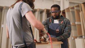 senior carpenter teaching apprentice standing at table in workshop,Carpenter working on wood craft at workshop to wooden furniture in workshop.profession,carpentry, woodwork and people concept. - Powered by Shutterstock - Get 15% off with code: PIKWIZARD15