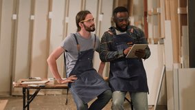 senior carpenter teaching apprentice standing at table in workshop,Carpenter working on wood craft at workshop to wooden furniture in workshop.profession,carpentry, woodwork and people concept. - Powered by Shutterstock - Get 15% off with code: PIKWIZARD15