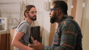 senior carpenter teaching apprentice standing at table in workshop,Carpenter working on wood craft at workshop to wooden furniture in workshop.profession,carpentry, woodwork and people concept. - Powered by Shutterstock - Get 15% off with code: PIKWIZARD15