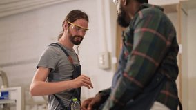 senior carpenter teaching apprentice standing at table in workshop,Carpenter working on wood craft at workshop to wooden furniture in workshop.profession,carpentry, woodwork and people concept. - Powered by Shutterstock - Get 15% off with code: PIKWIZARD15