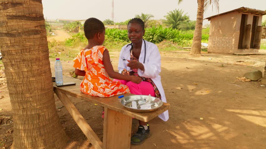 Black nurse doctor making diagnosis in remote clinic hospital of Africa to a young child performing a physical exam and test, healthcare in poor undeveloped areas community Royalty-Free Stock Footage #3414633955