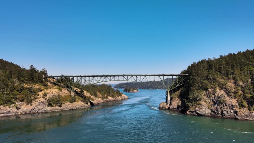 Aerial rising shot of vehicles crossing the Deception Pass in Washington Royalty-Free Stock Footage #3414635881
