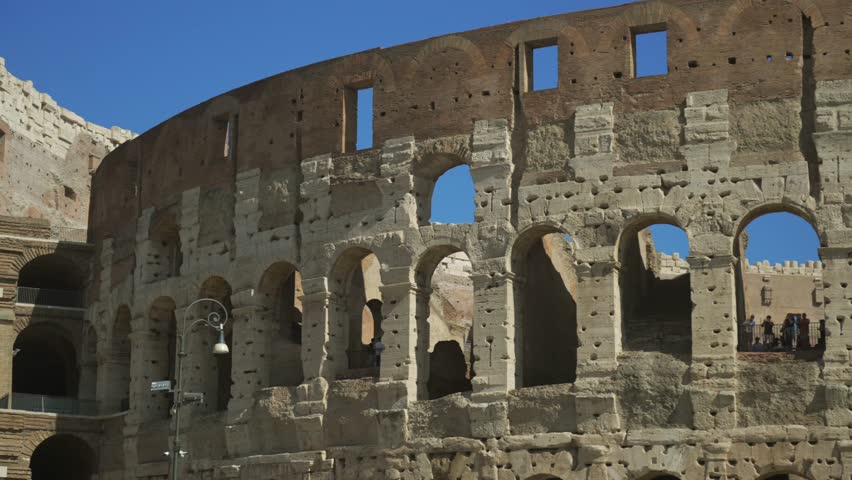 Rome, Italy. Colosseum or Coliseum in Rome, Italy. Famous ancient Roman monument, world landmark. Exterior of the Roman Colosseum with tourists visiting the city of Rome. 