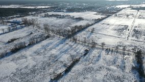 Rural landscape from drone, fields and meadows covered with snow in winter in Poland.