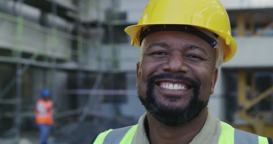 Face, construction site or happy black man with hardhat, smile or pride for architecture or building. Engineering, industrial development or safety of mature builder, maintenance worker or contractor