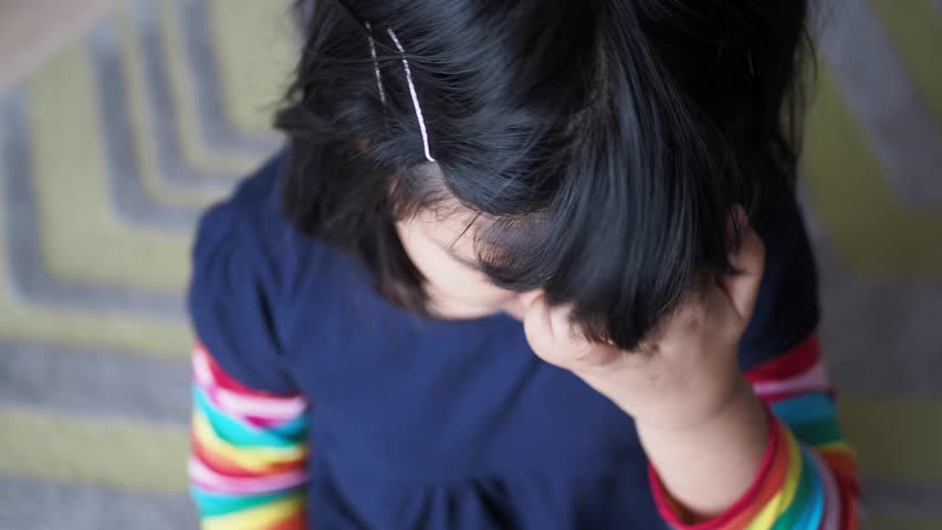 child Scratching her Head closeup