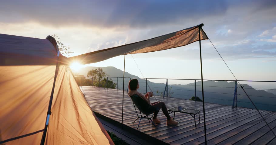 Woman enjoy snack in camping site in the evening