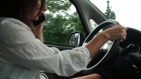 Happy woman talking on phone while driving in car on road Relaxed video call, professional conversation, female executive in automobile. business woman talking on video call on phone.