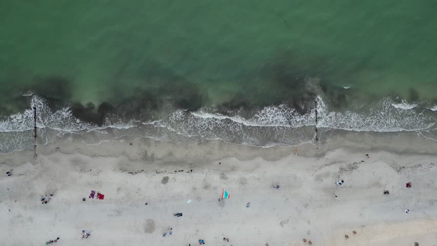 4k aerial footage of waves breaking on the white sands of Madeira Beach in Florida, USA