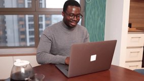 African American mid adult man working online from home