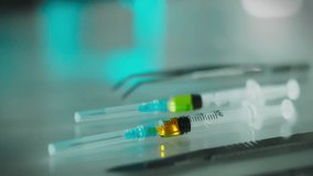 Wearing gloves, a professional anesthesiologist holds a syringe in his hand, preparing to administer intravenous medication. A young medical expert closely monitors the patient's surgical preparation. - Powered by Shutterstock - Get 15% off with code: PIKWIZARD15