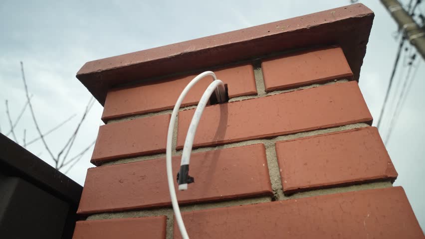 Electrical Wires are pulled out of the brick wall Royalty-Free Stock Footage #3415342661