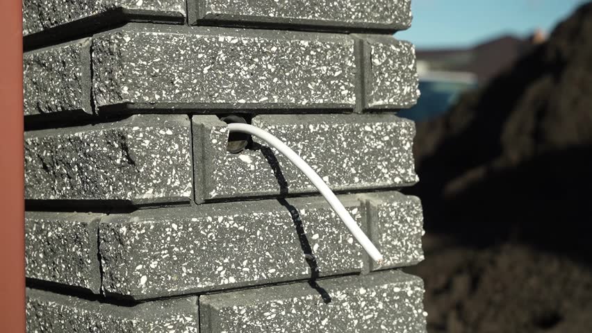 Electrical Wires are pulled out of the brick wall Royalty-Free Stock Footage #3415344961