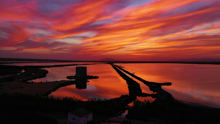 Spectacular aerial view at sunset in the Santapola Salt Flats, over the sea water lagoons, Spain.