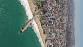 Aerial View Over Vergara Pier In Vina Del Mar With Hotel And Beach Coastline In Background. Vertical Video, Parallax Shot
