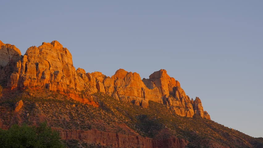 Establishing shot of mountains with red rocks in Grotto Road, Zion National Park, Utah, North America. Day time. ProRes 422 HQ.