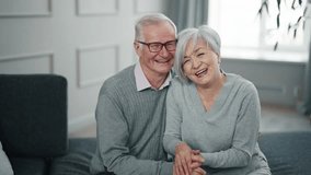 Senior couple talking on video chat. Happy positive man and woman speaking with family friends and laughing. Old wife husband having fun pleasant conversation chatting online.