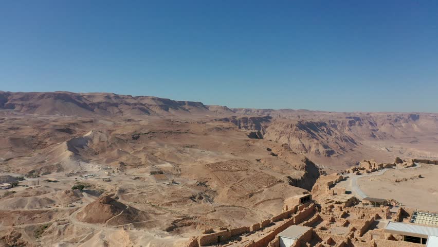 Aerial panoramic view of the Dead Sea and the ancient fortification Masada in the Southern District of Israel situated on top of an isolated rock plateau, eastern edge of the Judaean Desert, Israel