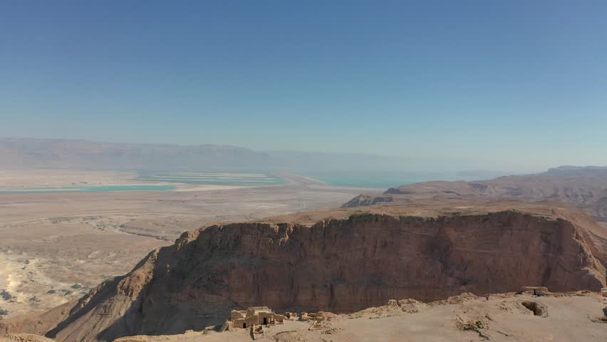 Aerial panoramic view of the Dead Sea and the ancient fortification Masada in the Southern District of Israel situated on top of an isolated rock plateau, eastern edge of the Judaean Desert, Israel