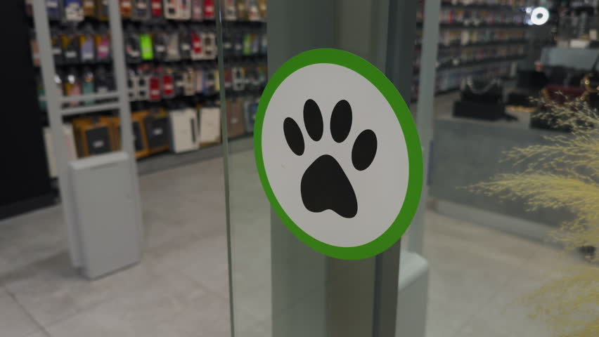 Dogs, pets allowed in a mall, green sign beckons animal companions