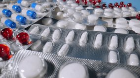 Closeup view of package with medical pills and drugs. Medicine, pills and tablets with blister packs. Shooting of different pills. Slow motion - Powered by Shutterstock - Get 15% off with code: PIKWIZARD15