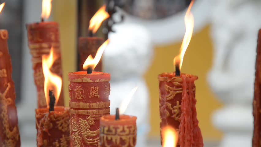 People light candles and incense in Xuedou Temple