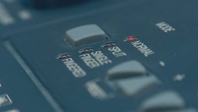 A man's finger presses gray square button of the synthesizer, switching Normal, Split, Single Finger, Fingered modes, which are confirmed by the lighting of the red LED. Closeup. Macro. Shot in motion - Powered by Shutterstock - Get 15% off with code: PIKWIZARD15