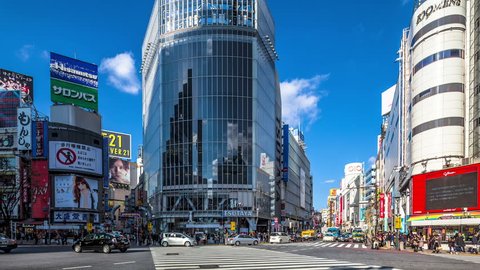TOKYO, JAPAN - DECEMBER 29: People and cars cross the famous intersection in Shibuya, Tokyo in time lapse on December 29, 2012. It is one of the most heavily used diagonal crossings in the world. Editorial Stock Video