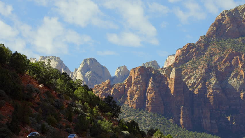 Establishing shot of mountains with red rocks in Zion Mount Carmel Highway, Zion National Park, Utah, North America. Day time. ProRes 422 HQ. Royalty-Free Stock Footage #3415757315