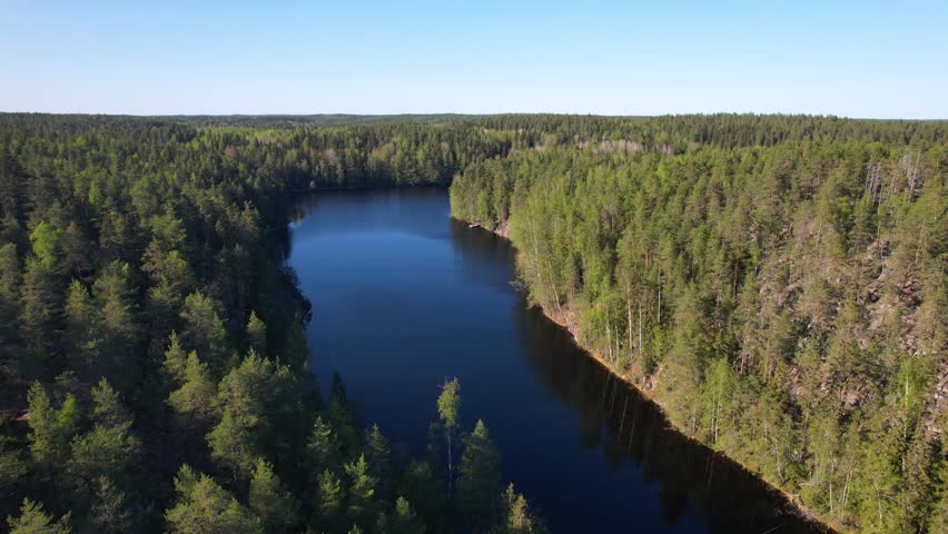 Descending aerial view to a forest lake in the Nuuksio national park in Finland Royalty-Free Stock Footage #3415823487