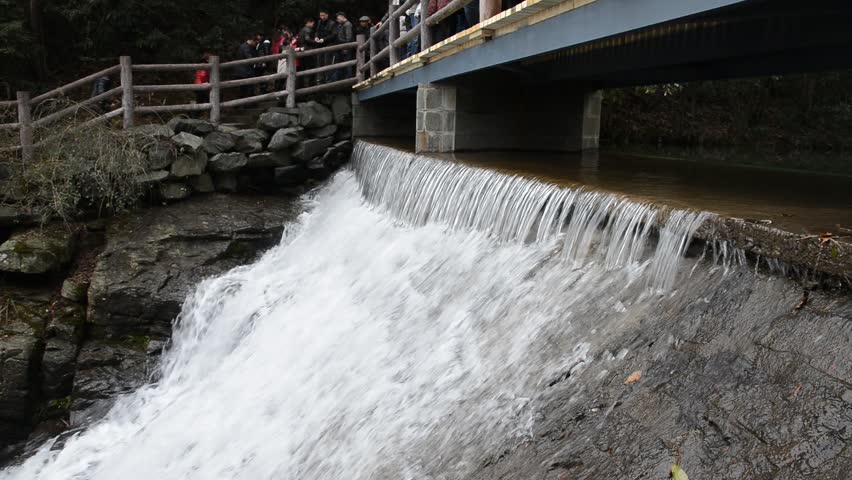 Ningbo,China - Feb 13:waterfall through bridge in qianzhangyan on Feb 13,2013 in