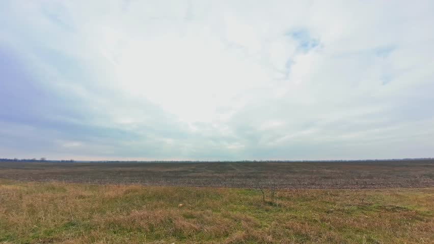 Timelapse in the autumn field, cloudy Royalty-Free Stock Footage #3415962023