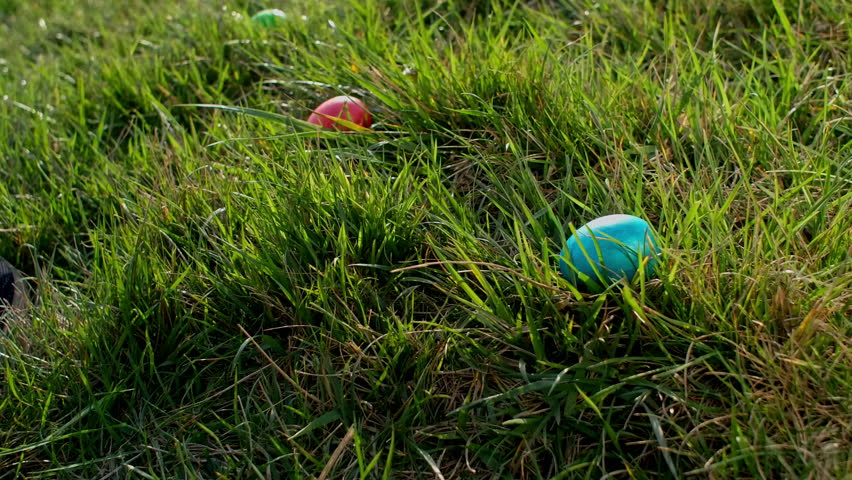 Basket with painted easter eggs, easter egg hunt game theme. Colored eggs in green grass to grab and collect, leisure game on holidays. The religious celebration of Easter. Royalty-Free Stock Footage #3416128691
