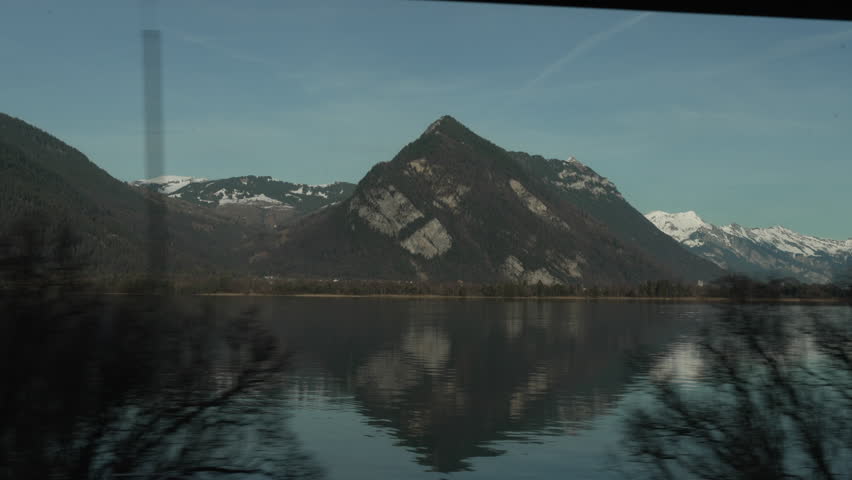 Swiss Lake and Mountains View from Moving Train