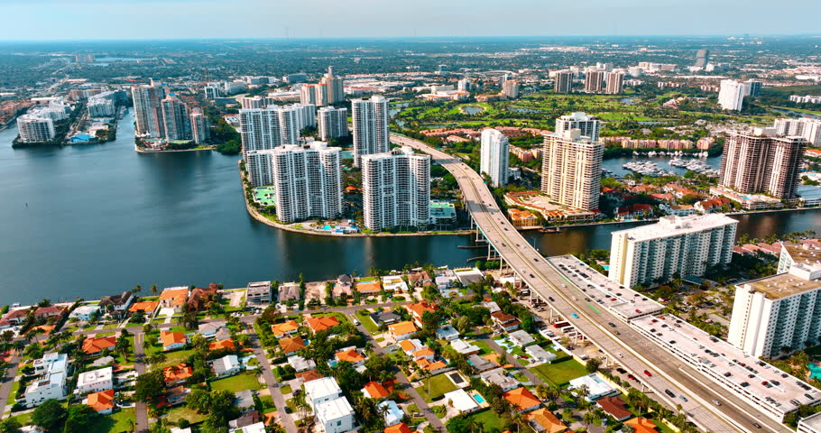 Breath-taking view on the sunny green urban area divided by the waterscape. Panorama of Miami, Florida, USA.
