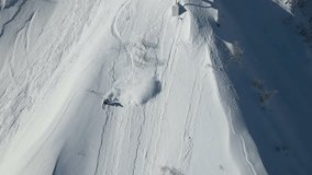 Drone view of a skier descending an unprepared slope in the mountains in winter. Off-piste skiing. Freeride