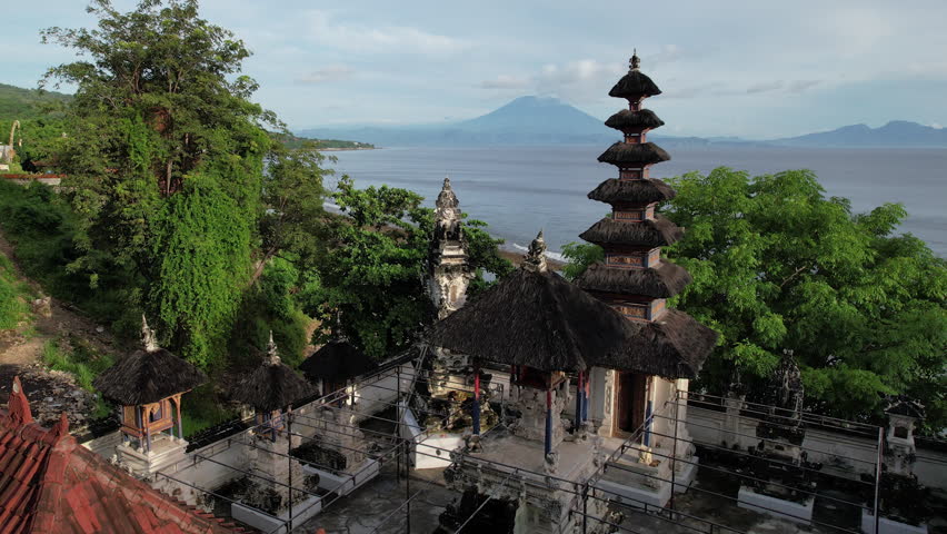 Forward reveal aerial shot of Segara Yeh Ulakan Hindu Temple on sunny day. Suana village, Nusa Penida, Indonesia.